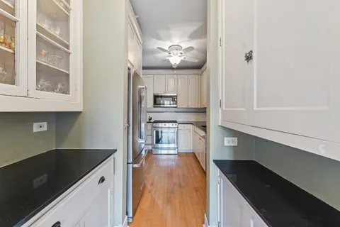 a kitchen with kitchen island a counter top space a sink and appliances