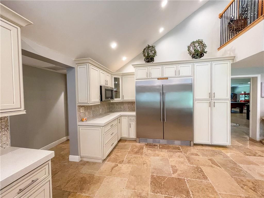 12990 Southwest 56th Street Southwest Ranches, FL 33330 - Photo 11 of 62 a kitchen with stainless steel appliances kitchen island granite countertop a refrigerator and a sink