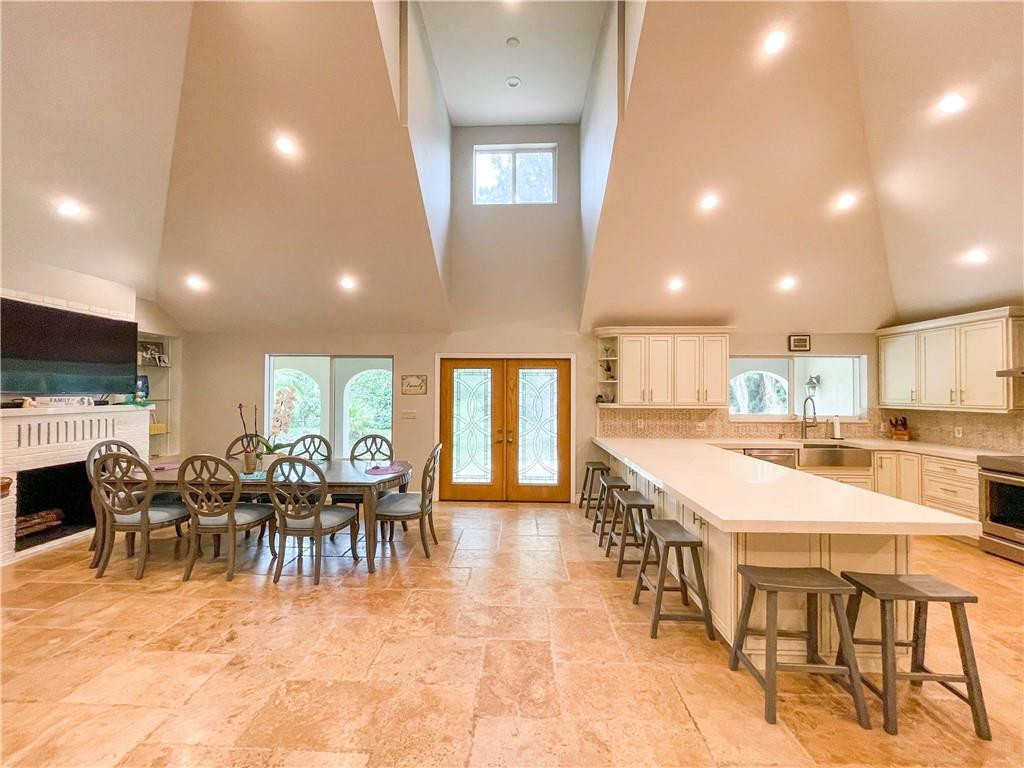 12990 Southwest 56th Street Southwest Ranches, FL 33330 - Photo 15 of 62 a large dining space with furniture a kitchen appliances and a window