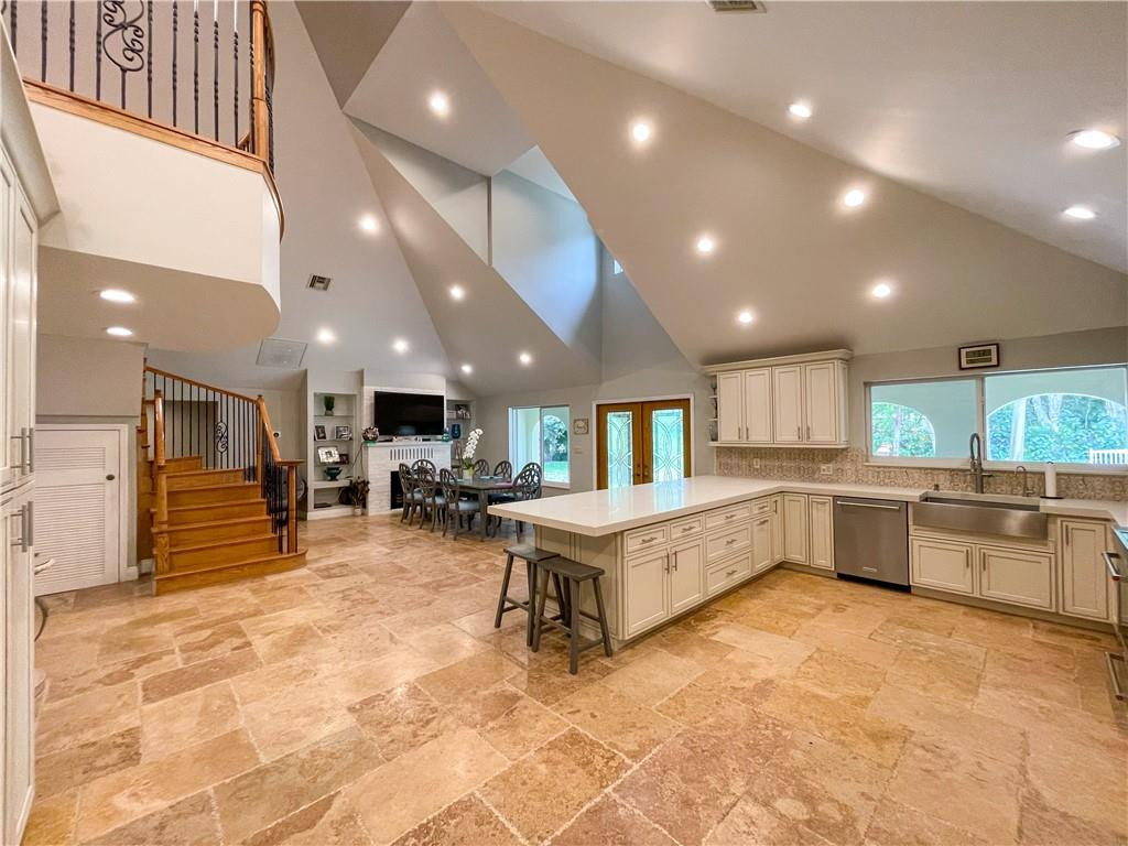 12990 Southwest 56th Street Southwest Ranches, FL 33330 - Photo 17 of 62 a large white kitchen with a large window and stainless steel appliances