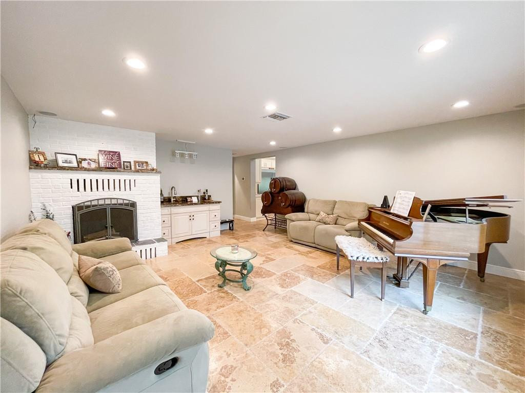 12990 Southwest 56th Street Southwest Ranches, FL 33330 - Photo 26 of 62 a living room with furniture a fireplace and a dining table with wooden floor