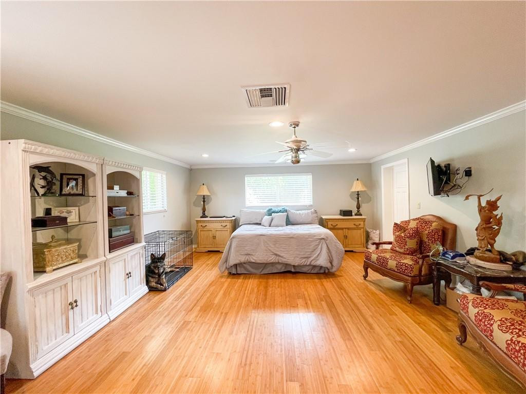 12990 Southwest 56th Street Southwest Ranches, FL 33330 - Photo 27 of 62 a spacious bedroom with a bed and wooden floor