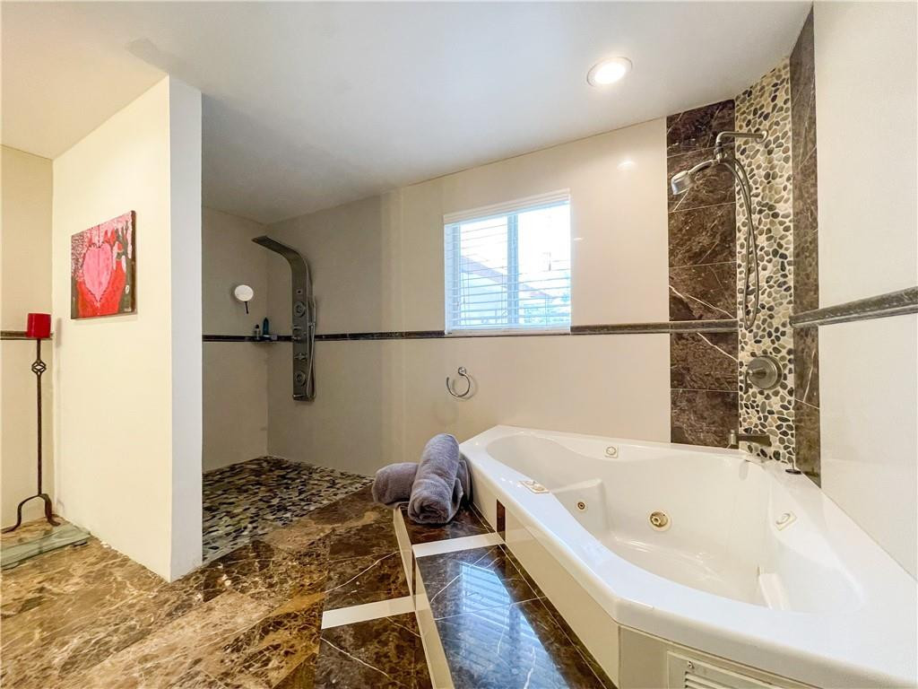 12990 Southwest 56th Street Southwest Ranches, FL 33330 - Photo 33 of 62 a bathroom with a bathtub and a shower