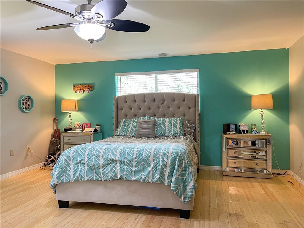 12990 Southwest 56th Street Southwest Ranches, FL 33330 - Photo 35 of 62 a bedroom with a bed and a chandelier