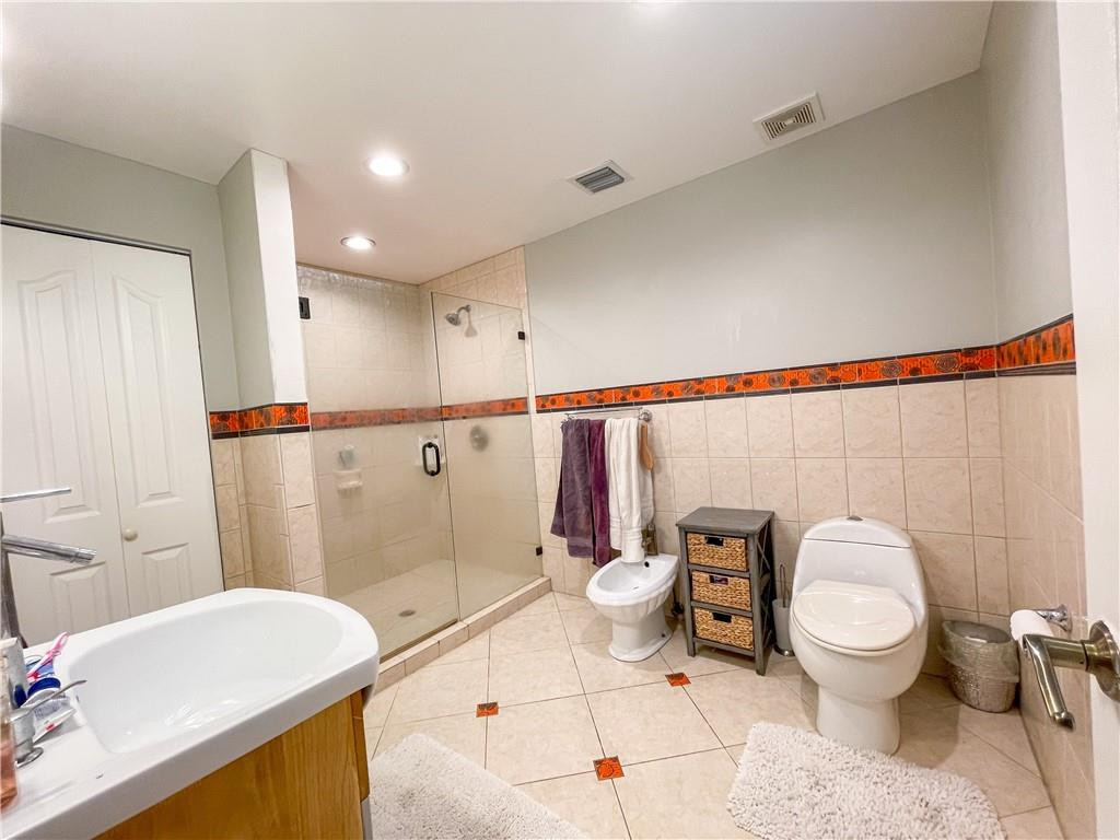 12990 Southwest 56th Street Southwest Ranches, FL 33330 - Photo 37 of 62 a bathroom with a sink a toilet and shower