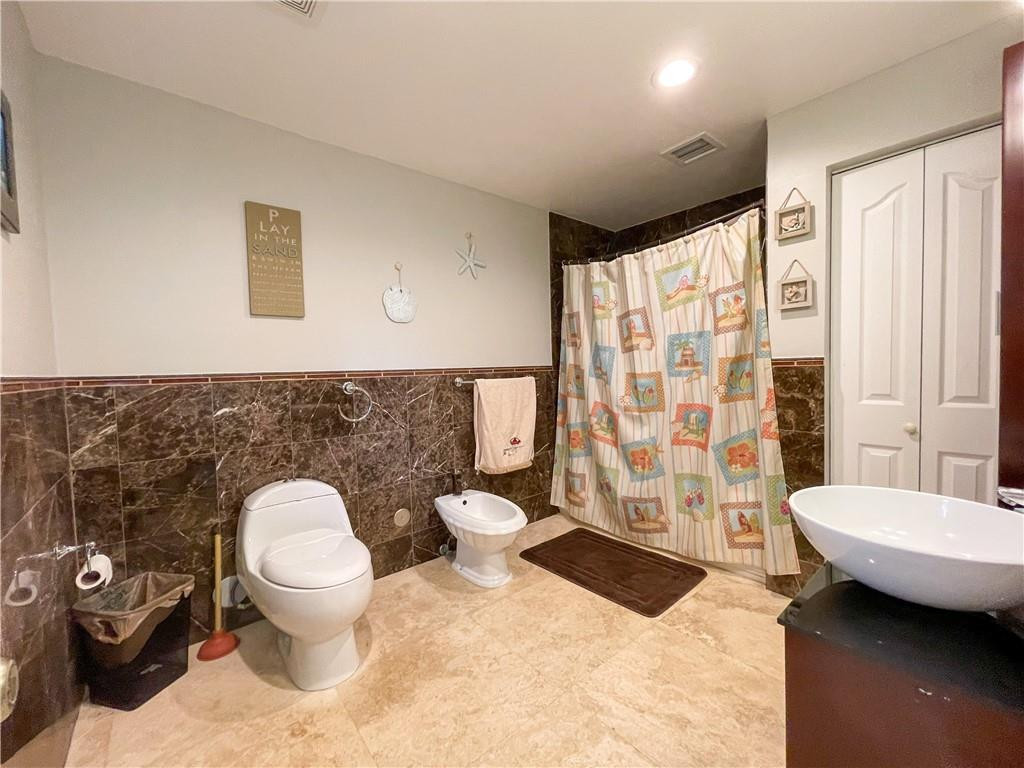 12990 Southwest 56th Street Southwest Ranches, FL 33330 - Photo 40 of 62 a bathroom with a toilet a sink and a shower