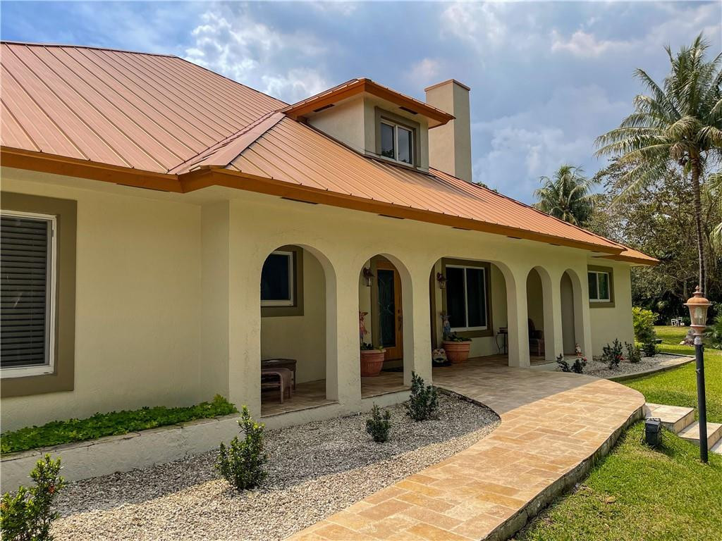 12990 Southwest 56th Street Southwest Ranches, FL 33330 - Photo 4 of 62 a front view of a house with garden
