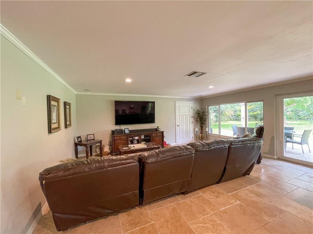 12990 Southwest 56th Street Southwest Ranches, FL 33330 - Photo 47 of 62 a living room with furniture and a flat screen tv