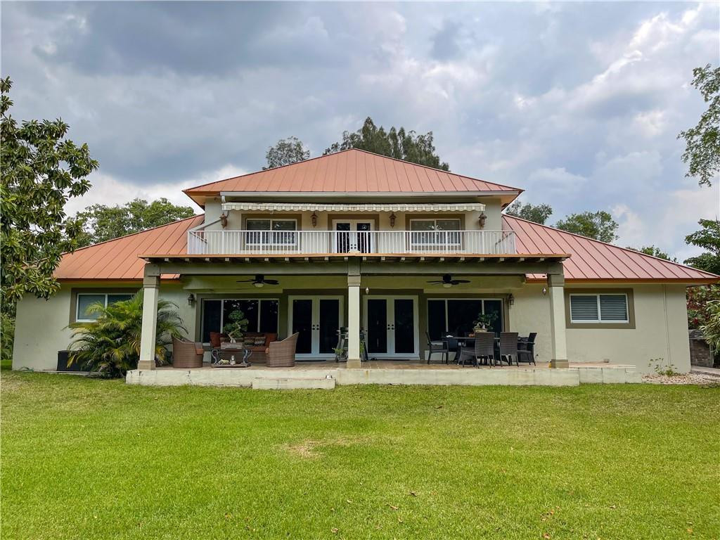 12990 Southwest 56th Street Southwest Ranches, FL 33330 - Photo 5 of 62 a front view of a house with swimming pool