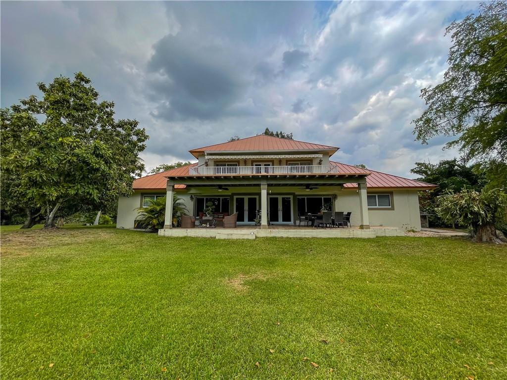 12990 Southwest 56th Street Southwest Ranches, FL 33330 - Photo 57 of 62 a front view of a house with a garden