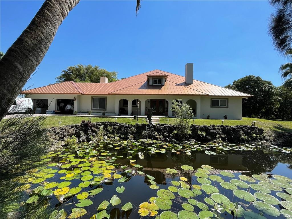 12990 Southwest 56th Street Southwest Ranches, FL 33330 - Photo 58 of 62 a front view of a house with a garden