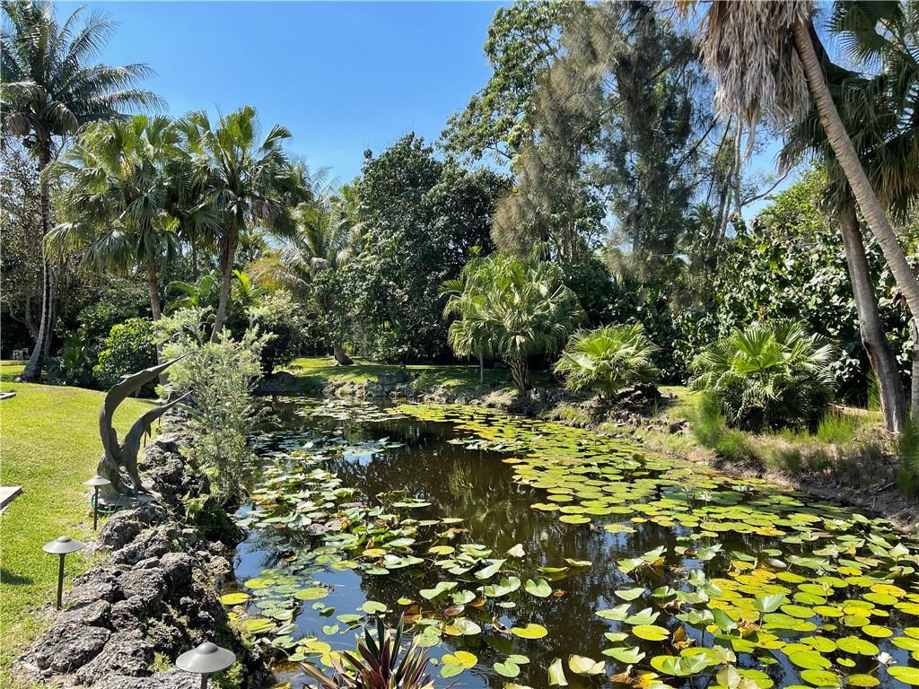 12990 Southwest 56th Street Southwest Ranches, FL 33330 - Photo 60 of 62 a backyard of a house with a yard and outdoor seating