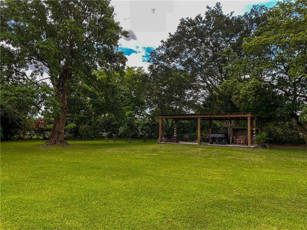 12990 Southwest 56th Street Southwest Ranches, FL 33330 - Photo 62 of 62 a view of a house with a yard and large trees