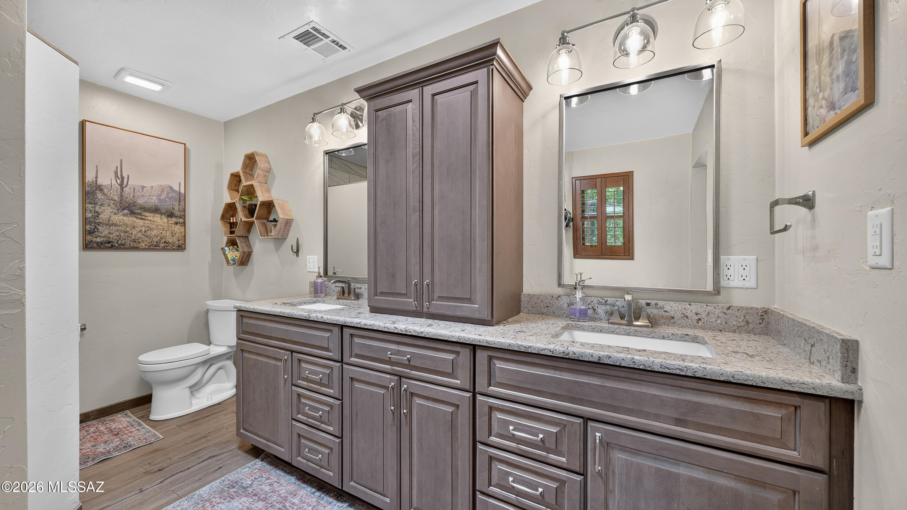 194 Taylor Road Willcox, AZ 85643 - Photo 26 of 54 Primary bathroom features a spacious double vanity with Cambria quartz countertops, dual undermount sinks, solid wood cabinetry, and upgraded soft-close doors and drawers throughout.
