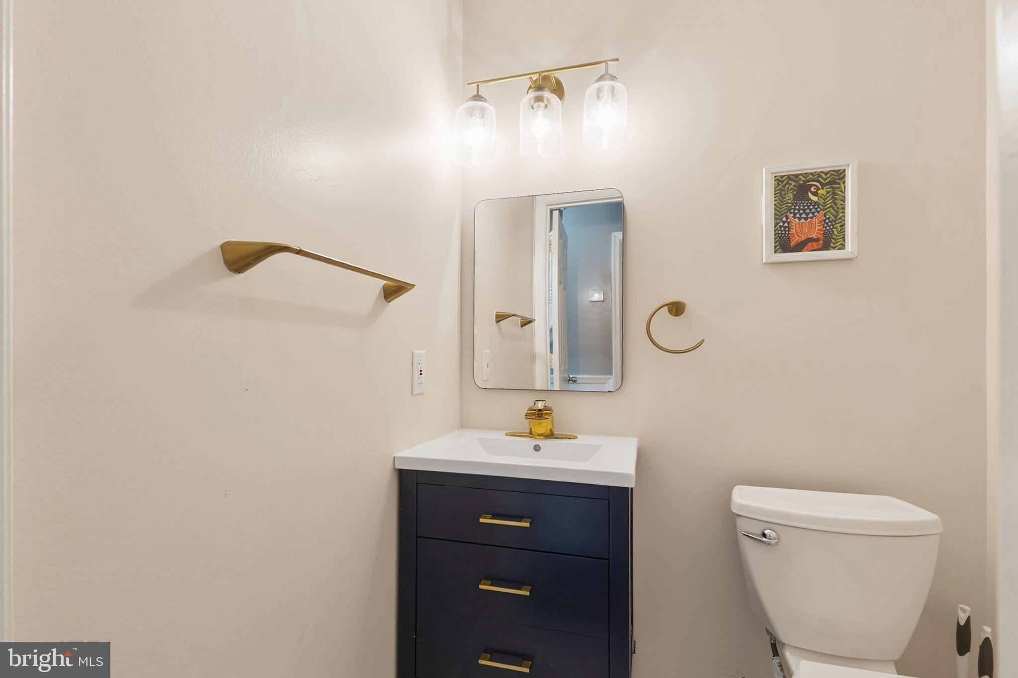 358 Kimwood Road Arnold, MD 21012 - Photo 12 of 15 a bathroom with a toilet a sink and mirror