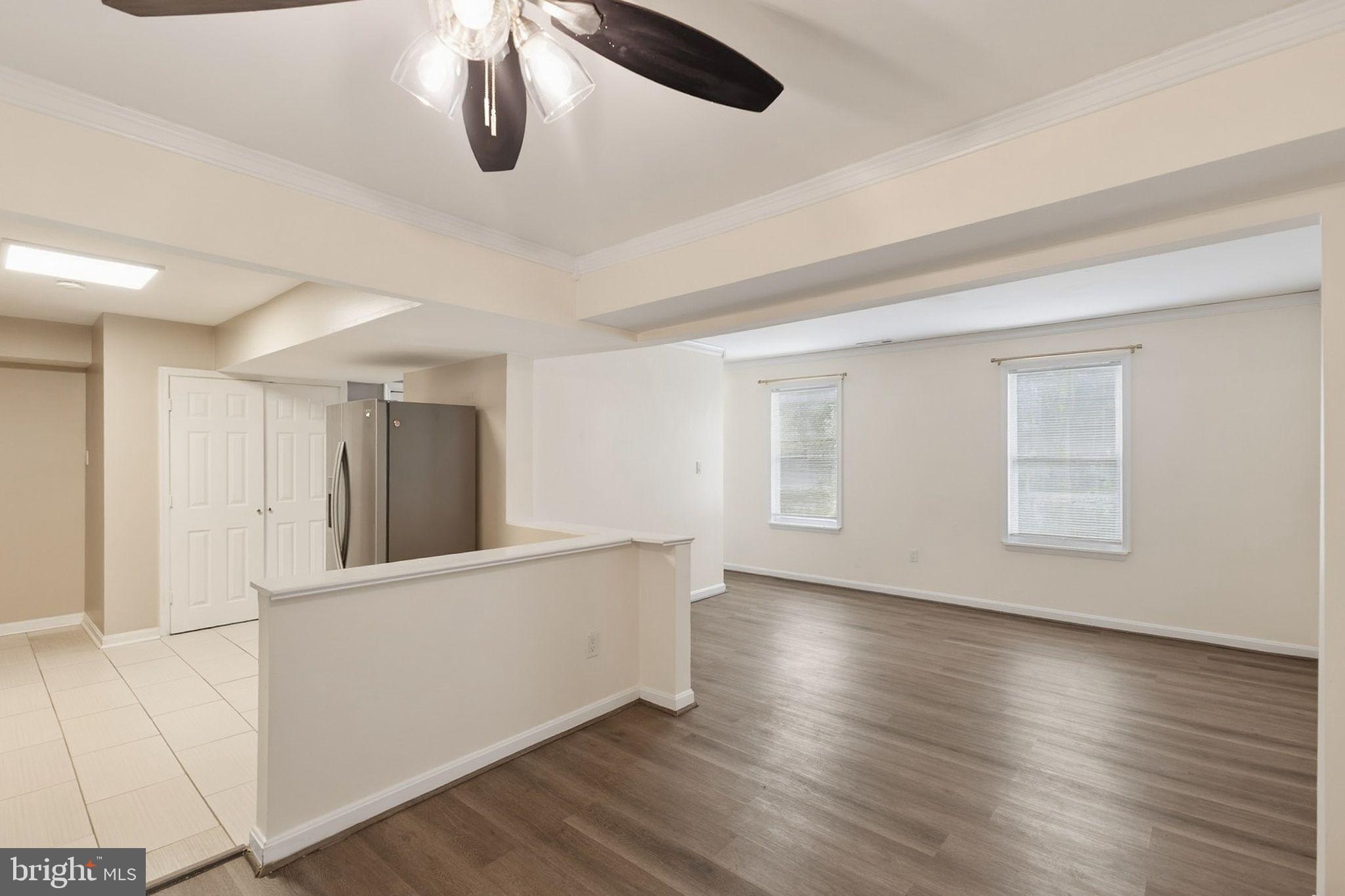 358 Kimwood Road Arnold, MD 21012 - Photo 3 of 15 a view of an empty room with wooden floor and windows