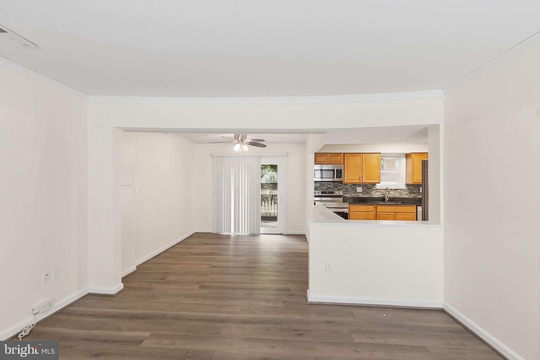 358 Kimwood Road Arnold, MD 21012 - Photo 4 of 15 a view of a kitchen with wooden floor and a refrigerator