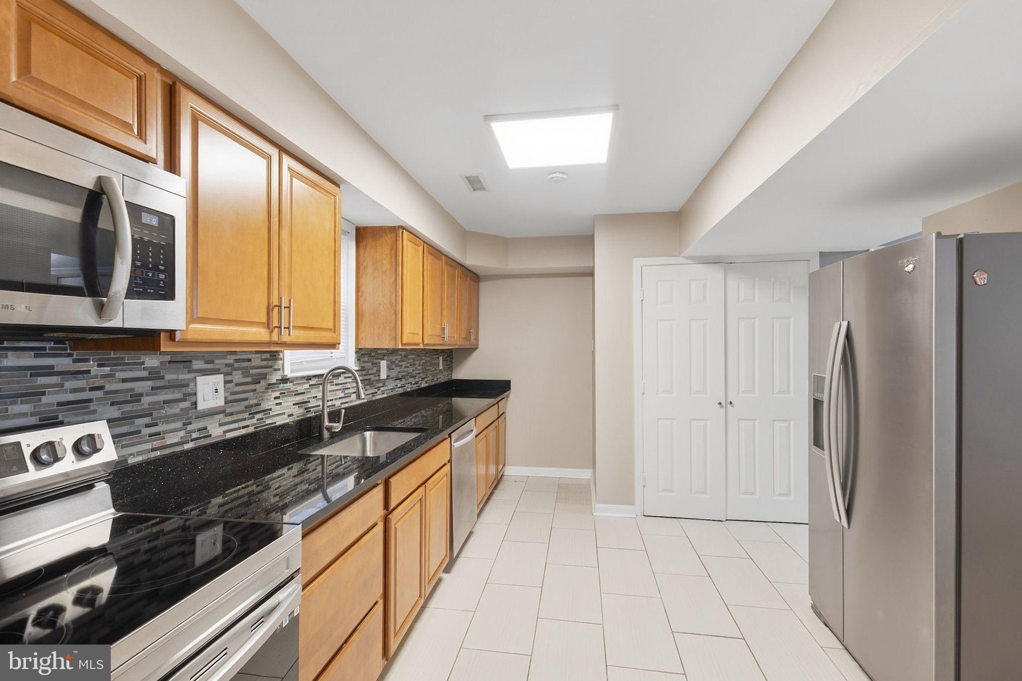 358 Kimwood Road Arnold, MD 21012 - Photo 5 of 15 a kitchen with stainless steel appliances granite countertop a stove a sink and a refrigerator
