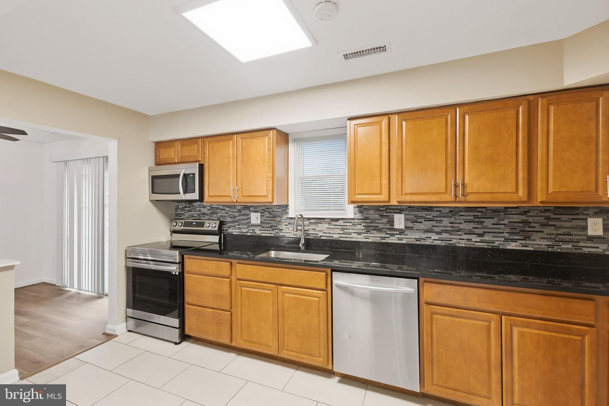 358 Kimwood Road Arnold, MD 21012 - Photo 6 of 15 a kitchen with stainless steel appliances granite countertop a stove a sink and a microwave
