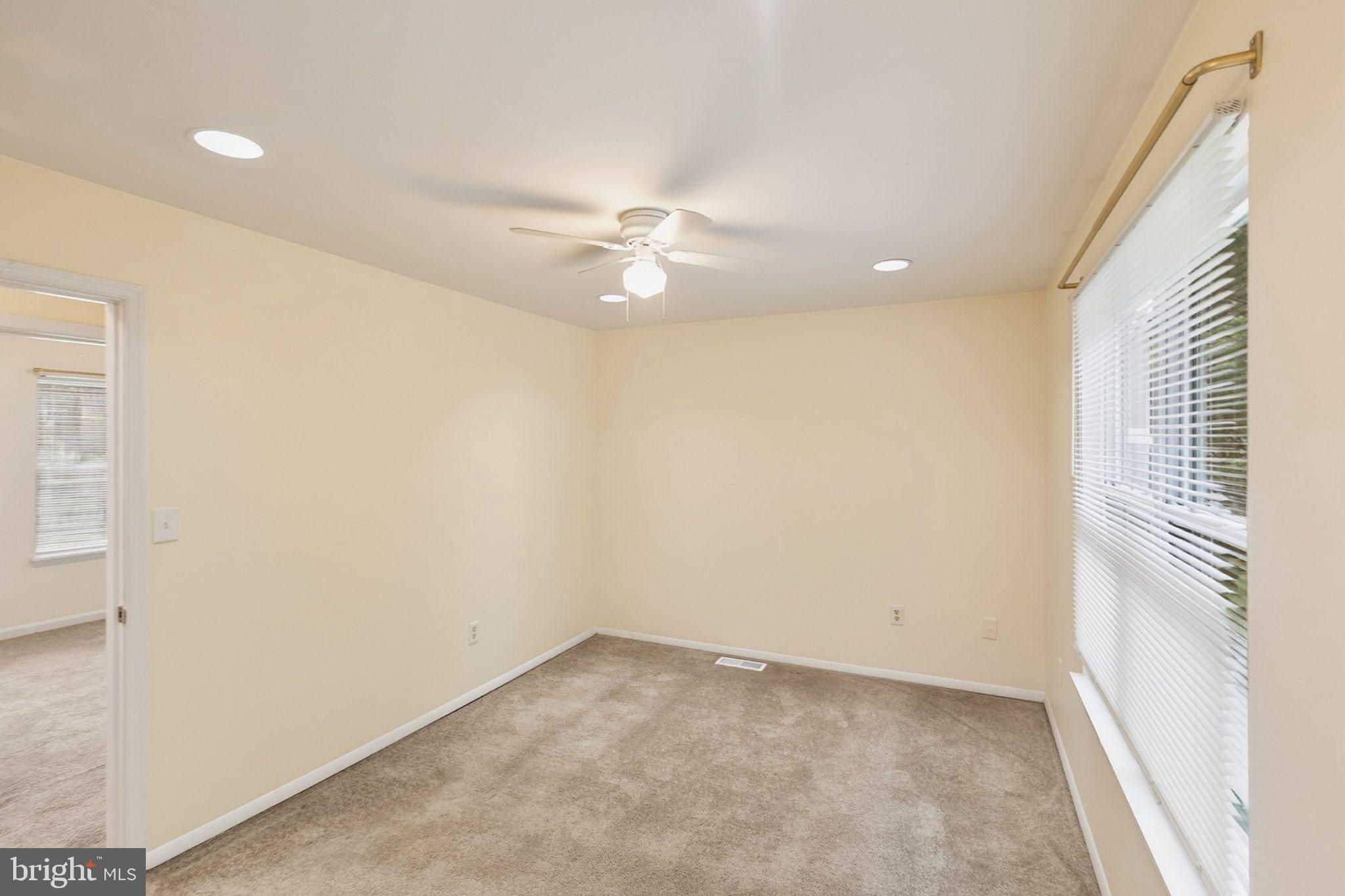 358 Kimwood Road Arnold, MD 21012 - Photo 7 of 15 an empty room with chandelier fan and windows