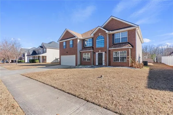 a front view of a house with a yard