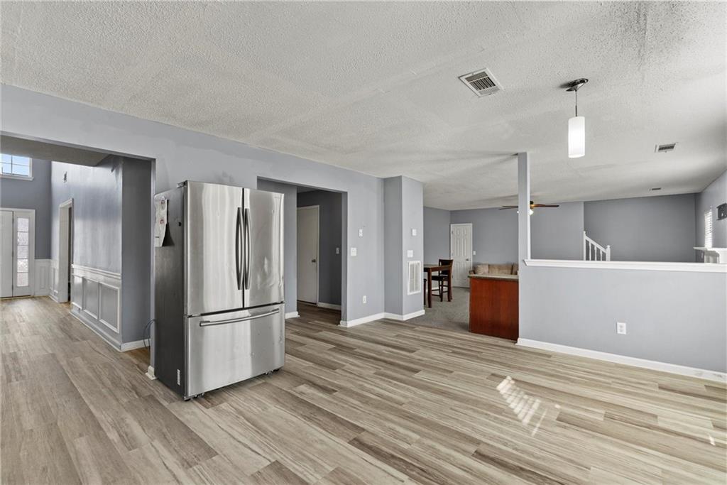 541 Hamlet Drive Hampton, GA 30228 - Photo 11 of 53 a view of a kitchen with refrigerator and wooden floor