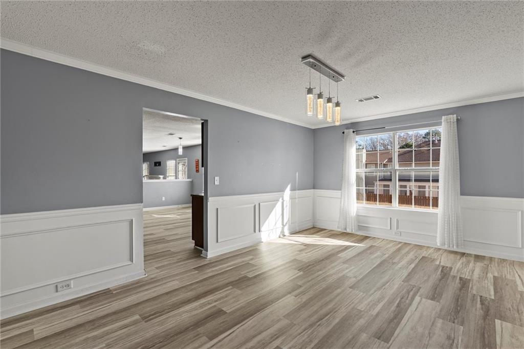 541 Hamlet Drive Hampton, GA 30228 - Photo 12 of 53 a view of empty room with wooden floor and fan