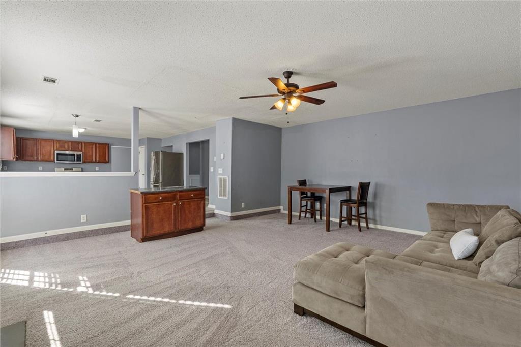 541 Hamlet Drive Hampton, GA 30228 - Photo 14 of 53 a living room with furniture and a table