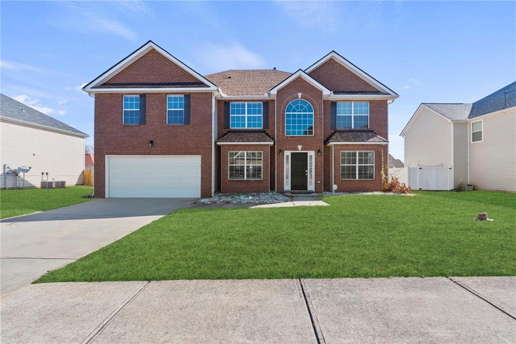 541 Hamlet Drive Hampton, GA 30228 - Photo 2 of 53 a front view of a house with a yard