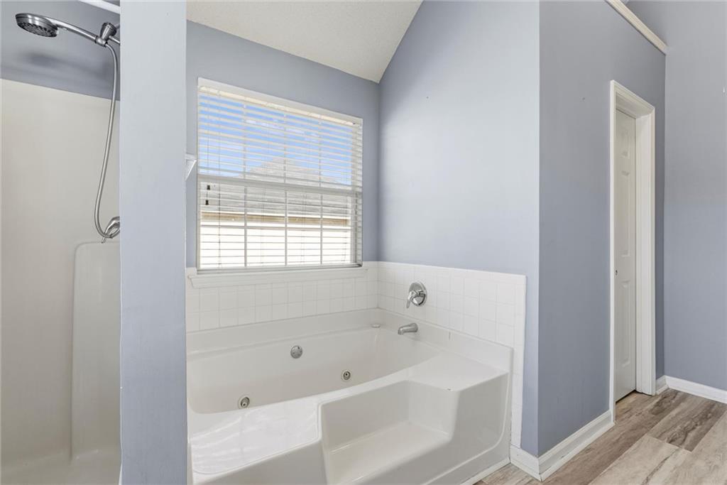 541 Hamlet Drive Hampton, GA 30228 - Photo 24 of 53 a white bath tub sitting next to a window
