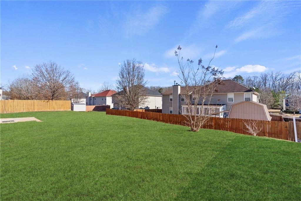541 Hamlet Drive Hampton, GA 30228 - Photo 31 of 53 a view of a house with a big yard and large trees