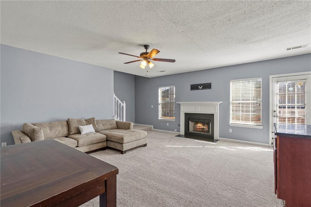 541 Hamlet Drive Hampton, GA 30228 - Photo 4 of 53 a living room with furniture and a fireplace