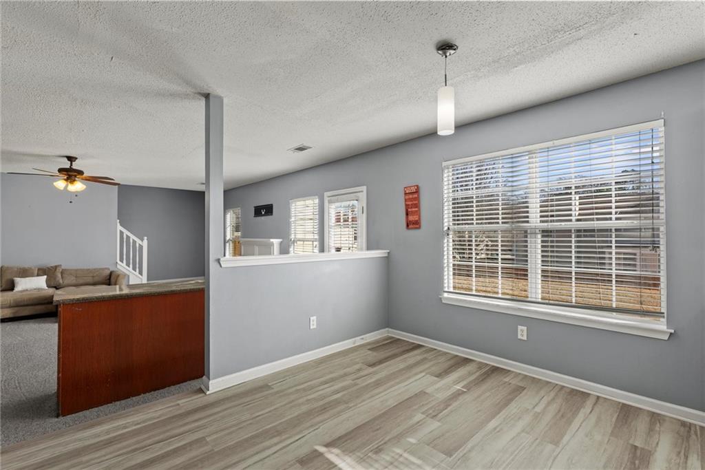 541 Hamlet Drive Hampton, GA 30228 - Photo 42 of 53 a view of a kitchen with a sink cabinet a fireplace and windows