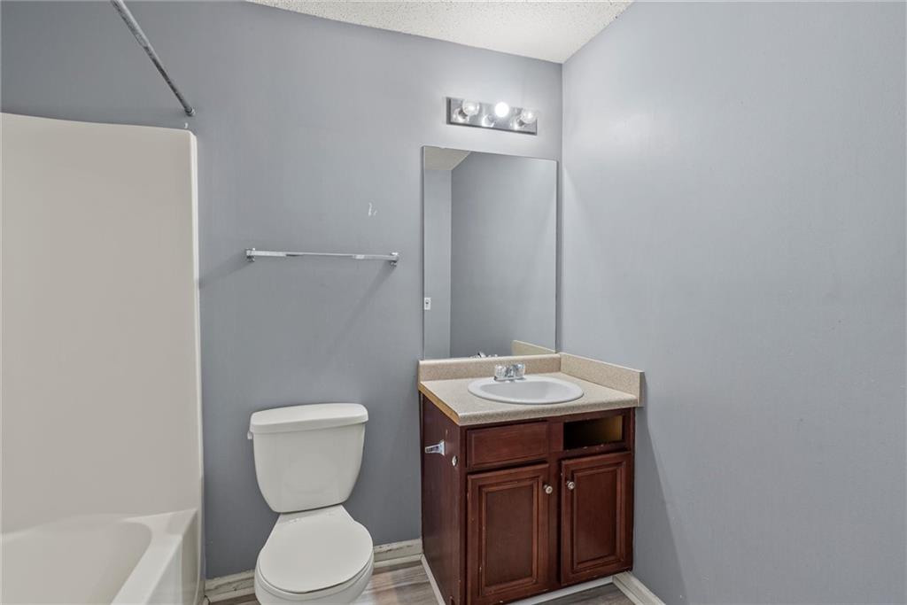 541 Hamlet Drive Hampton, GA 30228 - Photo 43 of 53 a bathroom with a toilet a sink and mirror