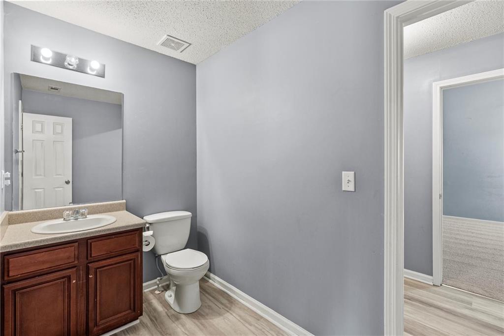 541 Hamlet Drive Hampton, GA 30228 - Photo 44 of 53 a bathroom with a toilet a sink and mirror