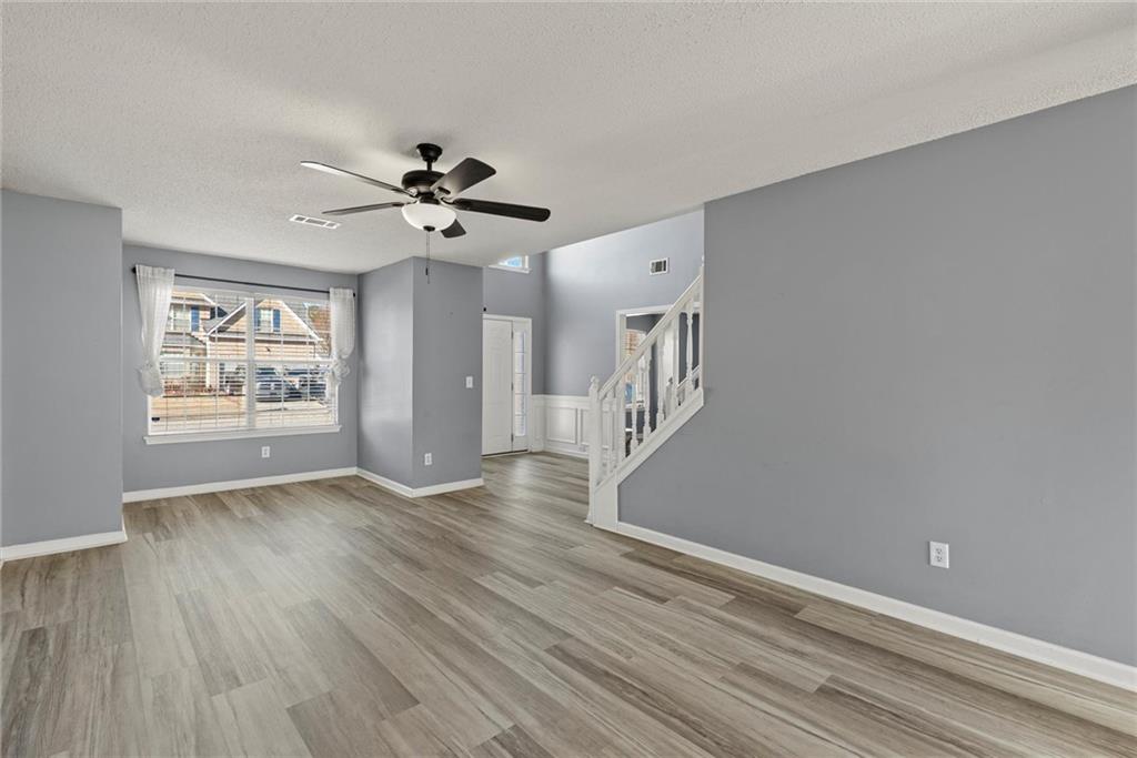 541 Hamlet Drive Hampton, GA 30228 - Photo 5 of 53 wooden floor in an empty room with a window