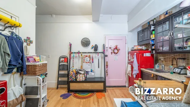 a utility room with stainless steel appliances lots of clutter