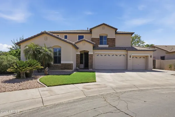 a front view of a house with a yard and a garage