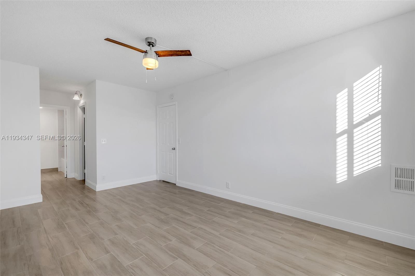 2501 Riverside Drive, Unit 307A Coral Springs, FL 33065 - Photo 14 of 28 an empty room with wooden floor cabinet and windows