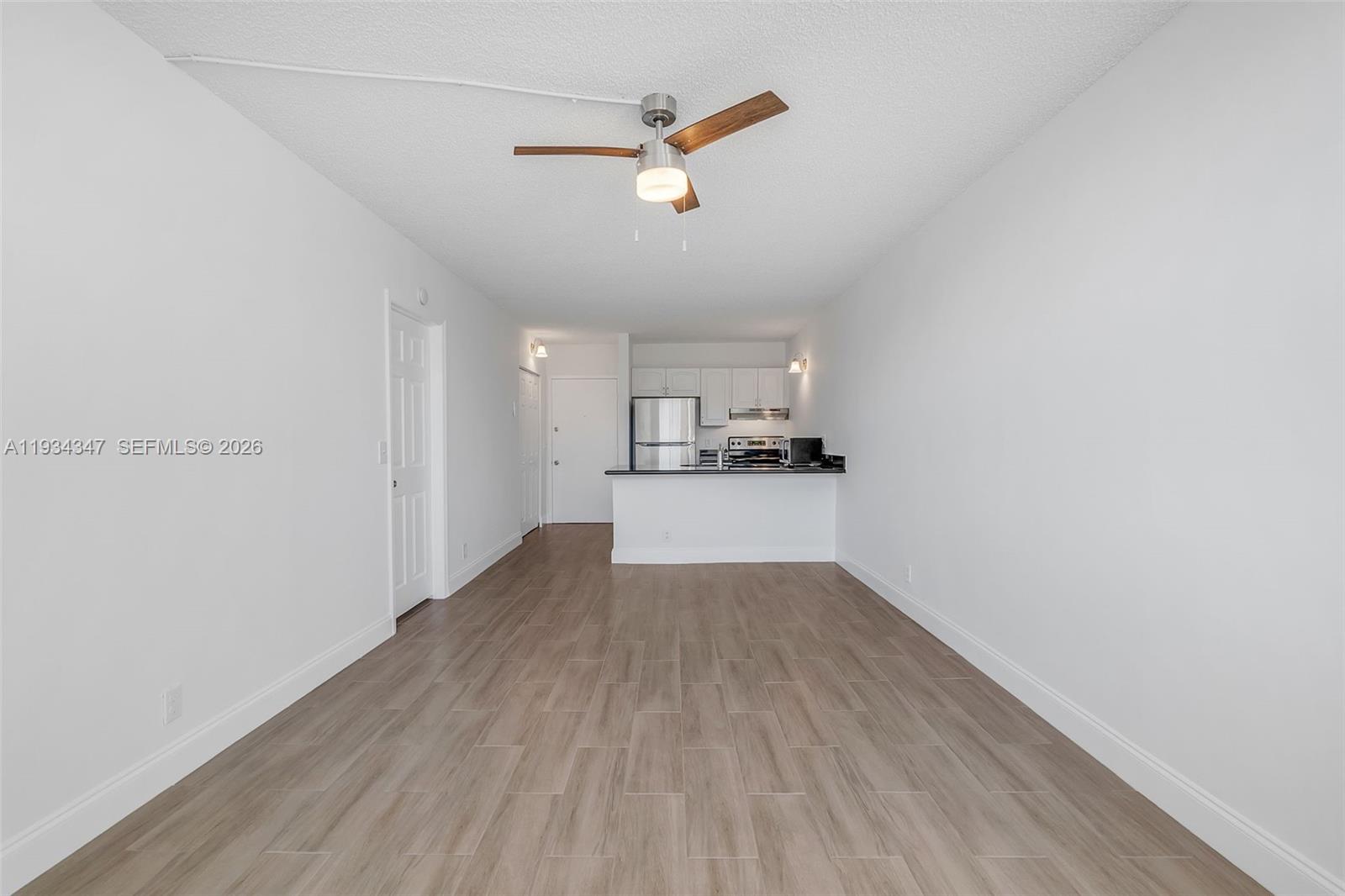 2501 Riverside Drive, Unit 307A Coral Springs, FL 33065 - Photo 3 of 28 a view of a kitchen with wooden floor and a ceiling fan