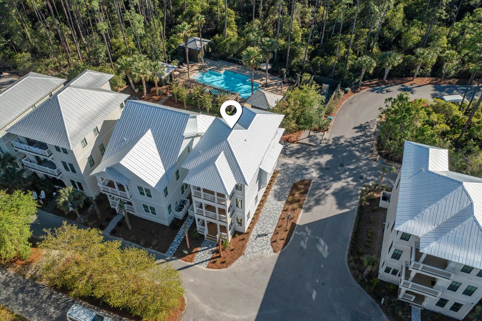 an aerial view of a house with wooden floor and city view