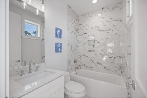 a bathroom with a granite countertop sink toilet a bathtub and a shower