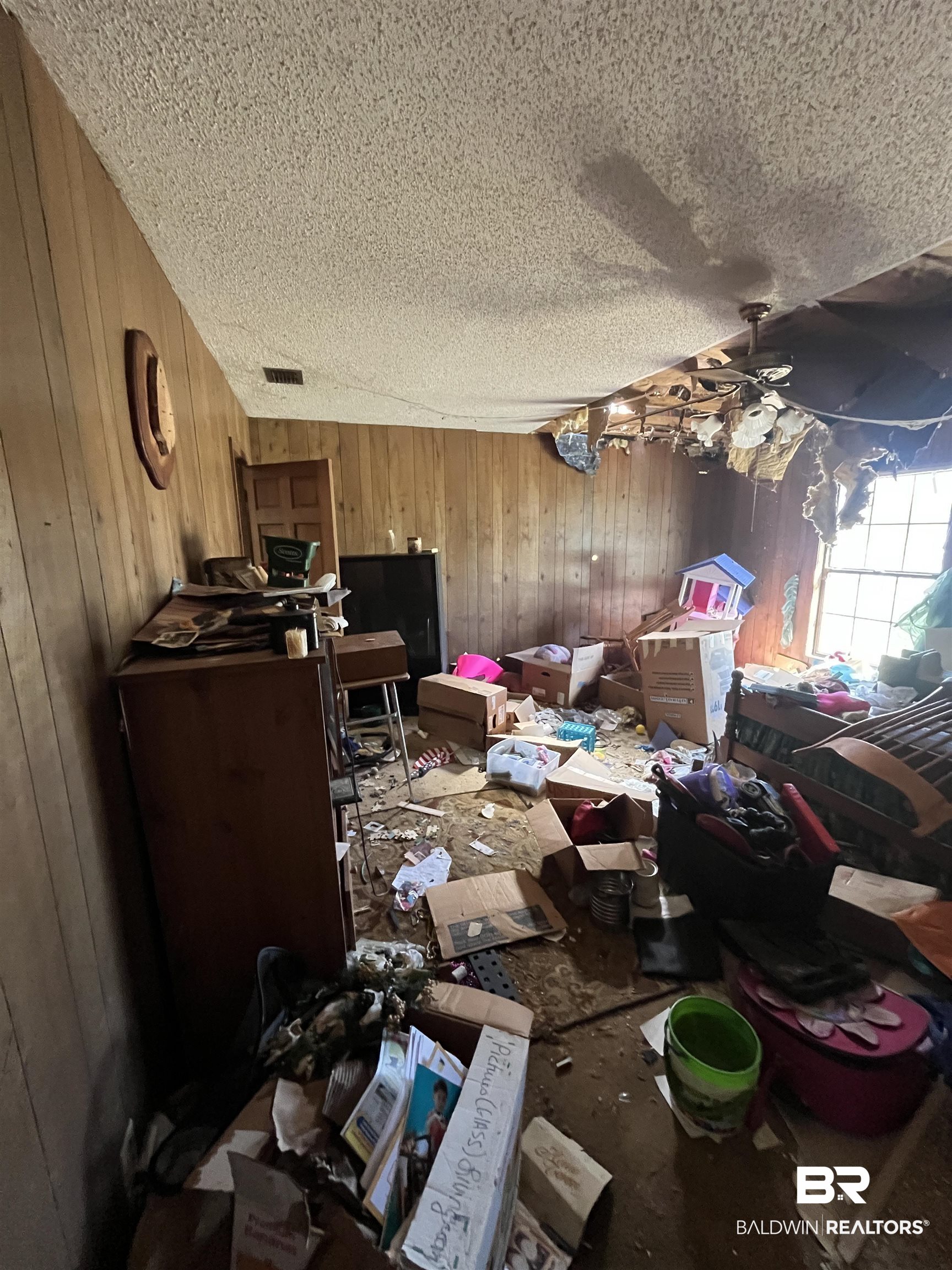 108 Powell Avenue Bay Minette, AL 36507 - Photo 31 of 39 Miscellaneous room with wood walls, ceiling fan, and a textured ceiling