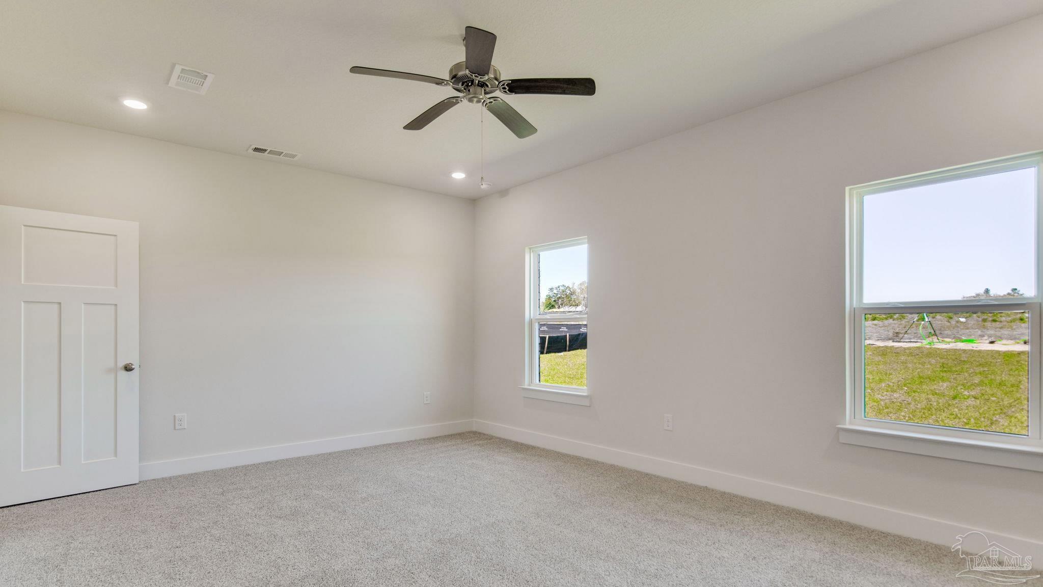 2733 Chevy Circle Pace, FL 32571 - Photo 19 of 37 an empty room with windows and fan
