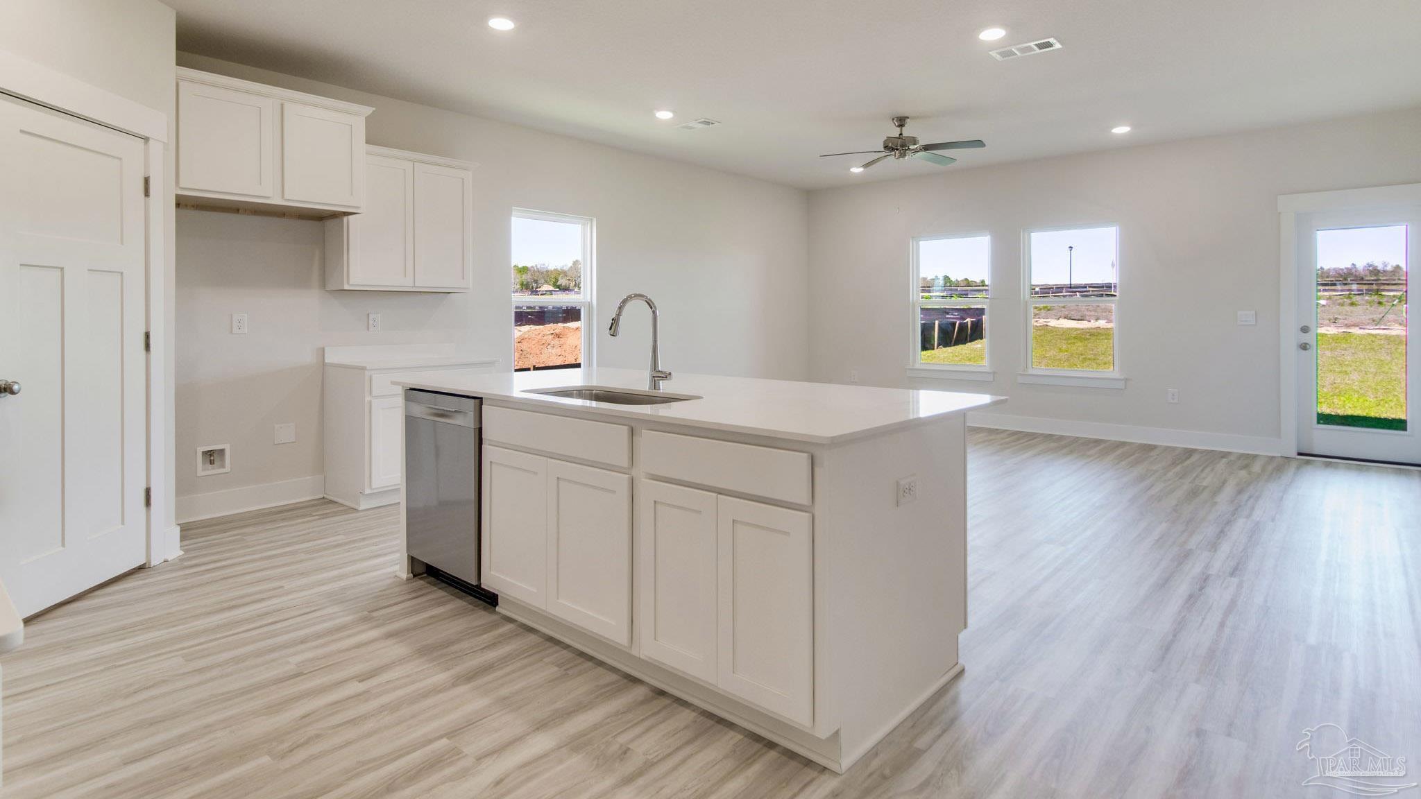 2733 Chevy Circle Pace, FL 32571 - Photo 6 of 37 a kitchen with a sink cabinets stainless steel appliances and windows