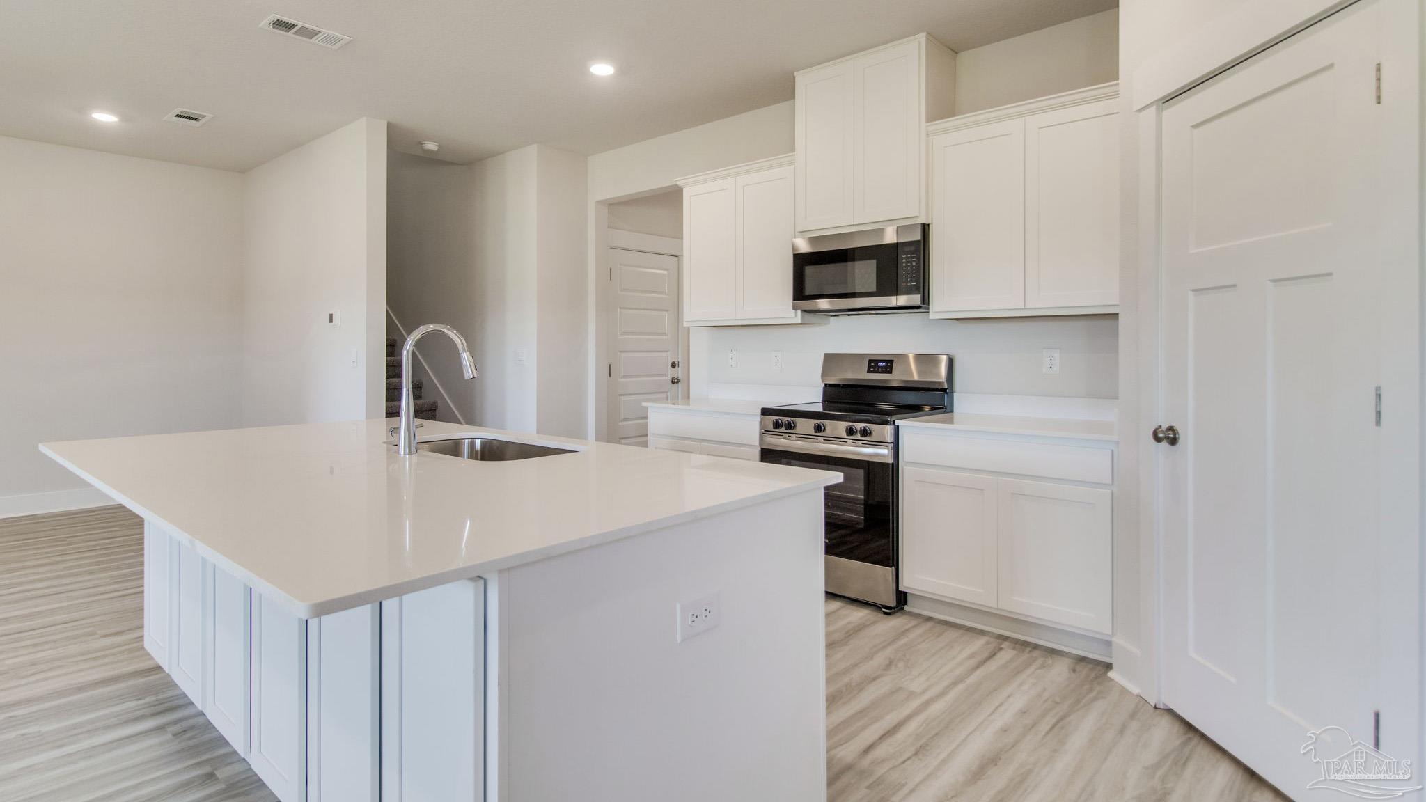 2733 Chevy Circle Pace, FL 32571 - Photo 10 of 37 a kitchen with stainless steel appliances a sink and a refrigerator