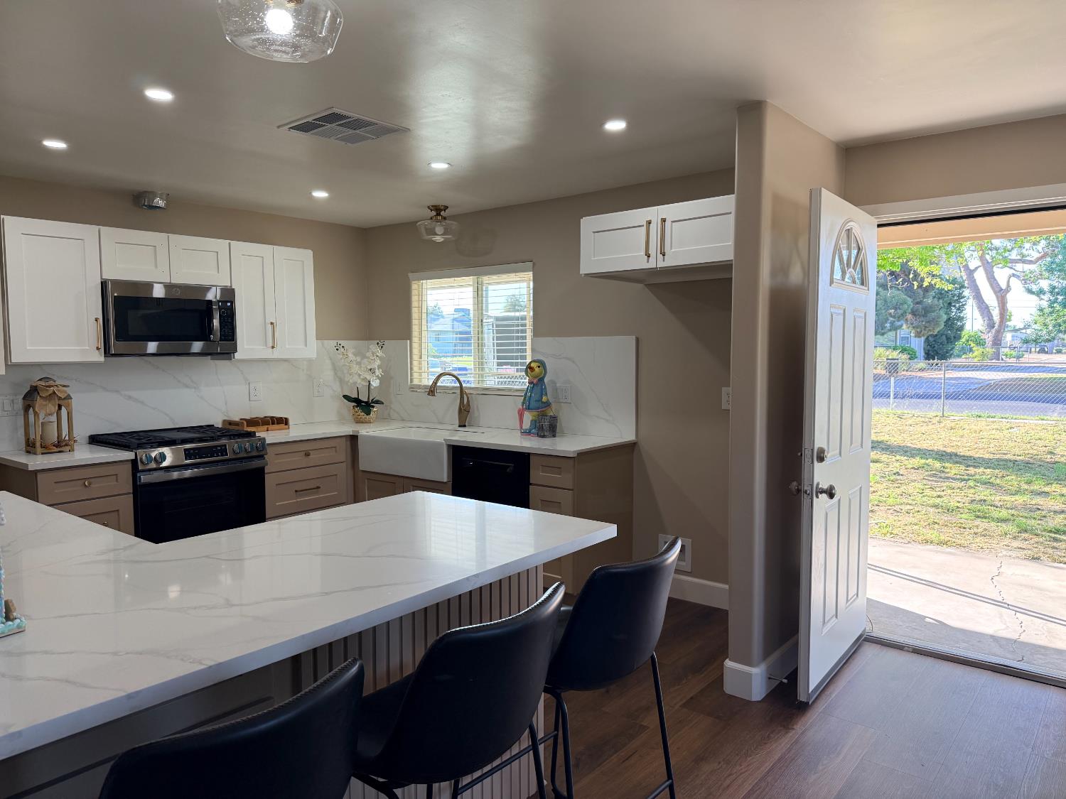 329 West Rialto Avenue Clovis, CA 93612 - Photo 2 of 2 a kitchen with stainless steel appliances a kitchen island hardwood floor sink stove dining table and chairs