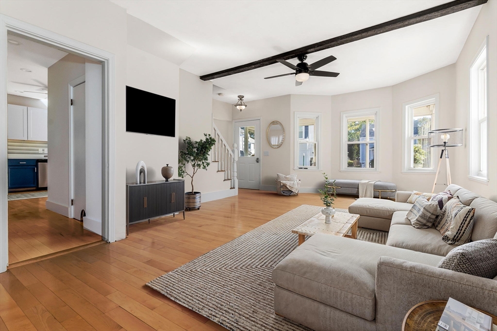a living room with furniture and a flat screen tv