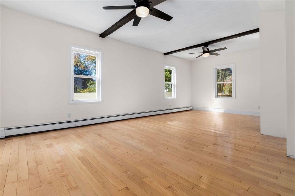 14 1/2 Hampshire Street Danvers, MA 01923 - Photo 12 of 37 a view of an empty room with a window and wooden floor