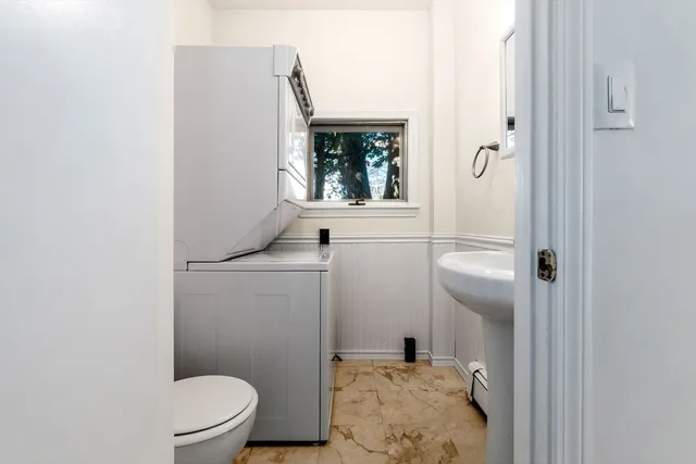 a bathroom with a sink a toilet and a mirror